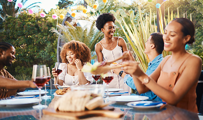 Image showing Group of friends at lunch, party in garden with smile, eating and happy event with diversity. Outdoor dinner, men and women at table with food, wine and talking together in backyard with celebration.