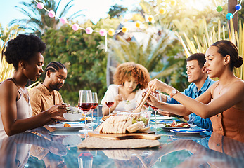 Image showing Friends at dinner, party in summer in garden and happy event with diversity, food and wine for bonding together. Outdoor lunch, men and women at table, group of people eating with drinks in backyard