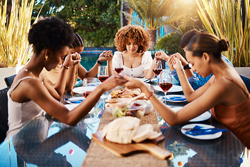 Image showing People, food and holding hands to pray outdoor at table for gratitude and holiday celebration. Group of people together at lunch, party or reunion with drinks in garden for thanks, prayer and grace