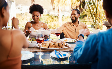 Image showing Group of friends at table, eating in garden and happy event with diversity, food and wine bonding together. Outdoor dinner, men and women at lunch, people at party with drinks in backyard in summer.
