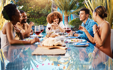 Image showing Friends, food and outdoor table for holiday, Christmas or thanksgiving lunch and wine at backyard patio. Young people or social group with alcohol, brunch and drink or talking of summer vacation