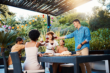 Image showing Cheers, wine and friends at dinner in garden at party and celebration in diversity, food and alcohol at outdoor event. Glass toast, men and women at table, fun people with drinks in backyard together