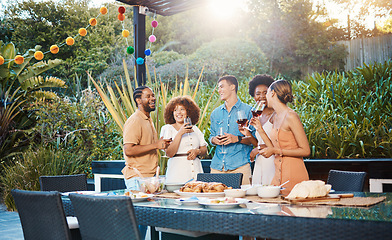 Image showing Laughing, diversity and friends at lunch in a garden with drinks, conversation and talking at a party. Happy, alcohol and group of men and women at an outdoor backyard dinner with communication