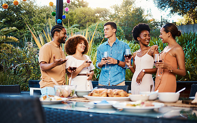 Image showing Talk, friends at dinner in garden at party and celebration with diversity, food and wine at outdoor event. Conversation, men and women at table for lunch, fun people with drinks in backyard together.