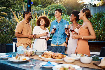 Image showing Chat, friends at dinner in garden at party and celebration with diversity, food and wine at outdoor event. Conversation, men and women at table, fun people with sunset drinks in backyard together.