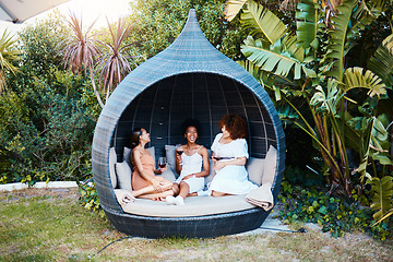 Image showing Travel, luxury and women or friends on vacation and in conversation happy for an outdoor getaway together. Wine, laughing and people on holiday in nature bonding in happiness in a modern tent