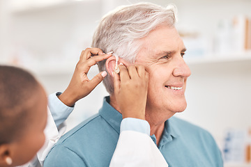 Image showing Helping, man and doctor with hearing aid, technology or healthcare or medical device consultation for deaf patient with tinnitus. Listening, test and exam ear tech with nurse or senior male in clinic