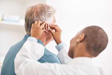 Image showing Doctor, helping and man with hearing aid, technology or healthcare or medical device consultation for deaf patient with tinnitus. Listening, test and exam ear tech with nurse or senior male in clinic