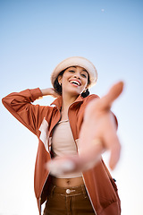 Image showing Portrait, woman smile and offer helping hand to welcome outdoor on low angle mockup space. Happy, palm and person giving assistance for support, care or acceptance of handshake sign for invitation