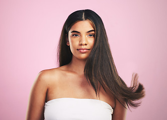 Image showing Hair care, wind and woman portrait with natural beauty and salon treatment in a studio. Shampoo, cosmetics and Brazilian hairstyle with a female model from Brazil with confidence with pink background