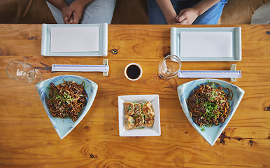 Image showing Chinese food, sushi and noodles on a table in a restaurant from above during a date in an asian eatery. Seafood, cuisine in a bowl and a traditional dish for hunger, nutrition or diet closeup