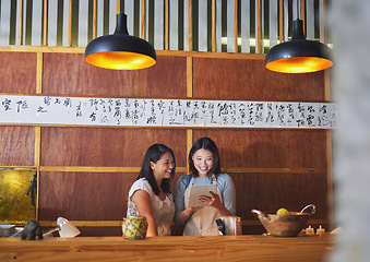 Image showing Restaurant, tablet and asian women at counter together checking sales, booking or menu for small business. Social media, content marketing and startup cafe owner with waitress scroll on digital app.