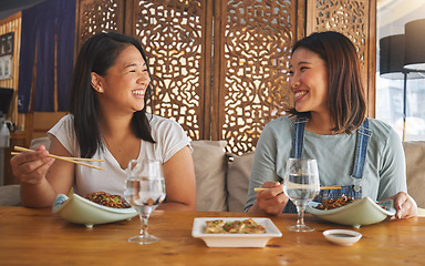 Image showing Restaurant, girl friends and laughing with food, noodles and cafe happy from bonding. Asian women, eating and plate together with friendship smile at a table hungry with chopsticks at Japanese bar