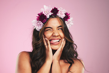 Image showing Beauty, flowers and wink with hairstyle of woman in studio for cosmetics, skincare and wellness. Self care, spa treatment and crown with face of person on pink background for spring, glow and makeup