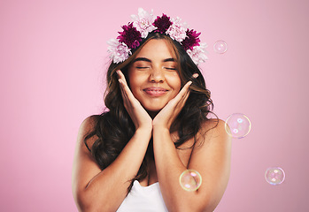 Image showing Beauty, relax and bubbles with woman and flower crown in studio for cosmetics, skincare and wellness. Hair care, spa treatment and face with person on pink background for spring, glow and makeup
