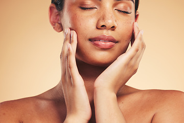 Image showing Skincare, beauty and natural face of woman with hands for wellness, health and facial care in studio. Dermatology, spa and eyes closed of person on brown background in cosmetics, glow or satisfaction