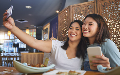 Image showing Selfie, lgbt and a gay couple in an asian restaurant for a romantic date together on an anniversary. Lesbian, smile and happy asian woman with her partner in a cafe for eating or celebration of love