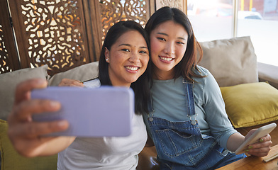 Image showing Selfie, love and a lesbian couple in a restaurant for a romantic date together on their anniversary. LGBT, smile and happy asian woman with her partner in a cafe for celebration of a milestone event