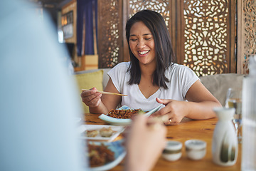 Image showing Happy, lunch and a woman at a restaurant for Chinese food or bonding at a table. Smile, hungry and a girl or people at a cafe for fine dining, Asian cuisine or eating dinner or a meal together