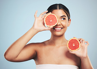 Image showing Smile, skincare and woman in studio with grapefruit for natural skin beauty or wellness on grey background. Happy, fruit and female model with citrus cosmetics for vitamin c, collagen and exfoliate