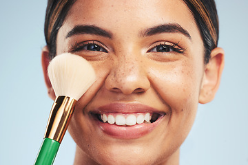 Image showing Portrait, happy woman and brush for makeup in studio, apply foundation and glow on blue background. Closeup face of model smile for aesthetic cosmetics, skincare tools and beauty powder for makeover