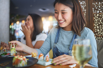 Image showing Japanese woman, restaurant and eating sushi with smile, chopsticks and excited for fine dining at party. Asian friends, fish and healthy with culture, traditional or fast food in diner, bar or shop