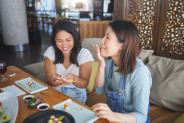 Image showing Girl friends, sushi restaurant and eating together with comic laugh, joke and fail with chopsticks at table. Japanese women, happy and excited with fish, seafood or diner with help, mistake or memory