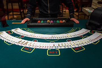 Image showing Professional croupier during cards