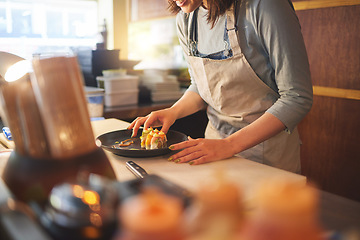 Image showing Sushi chef, restaurant and ready in kitchen with hands, service or plate on table, job or catering. Small business, fast food and cooking in cafe, startup diner and working with fish, rice or seaweed