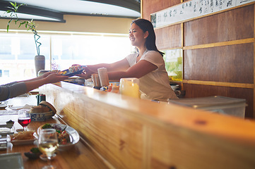 Image showing Sushi serving, restaurant chef and woman with smile from food and Asian meal in a kitchen. Happy, female waiter working with lunch order with cooking and hospitality job in Japanese bar with service