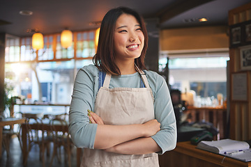 Image showing Smile, thinking and arms crossed with an asian woman in a restaurant working as a waitress for service. Hospitality, happy and idea with a young employee in a chinese eatery for local cuisine