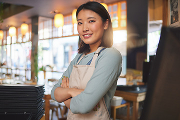 Image showing Waitress, portrait and Asian woman with arms crossed at cafe, coffee shop or store. Face, smile and confident barista, happy employee or small business entrepreneur at restaurant startup in Japan