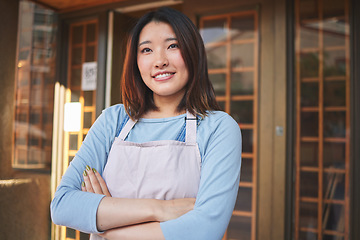 Image showing Happy, waitress and Asian woman with arms crossed at restaurant, coffee shop or startup store. Idea, smile and confident barista, thinking employee or small business entrepreneur at cafe in Japan