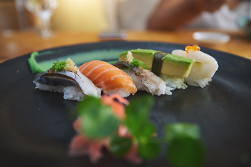 Image showing Japanese, sushi and luxury food at a restaurant for dinner or lunch meal at a healthy Asian cafe on table. Plate, cuisine and fine dining takeaway or seafood from a Salmon menu for diet or nutrition