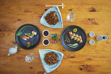 Image showing Sushi restaurant, catering and plate in top view for service, lunch or dinner with soy sauce, chopsticks or fish. Japanese cuisine, platter and food in cafe, luxury and eating for nutrition in diet