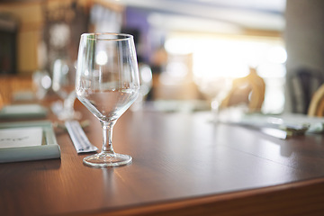 Image showing Bokeh, lunch and glass on a table at a restaurant for water, alcohol or wine. Dinner, crystal and tableware for a drink at a coffee shop or cafe during dinner for a luxury and fine dining experience