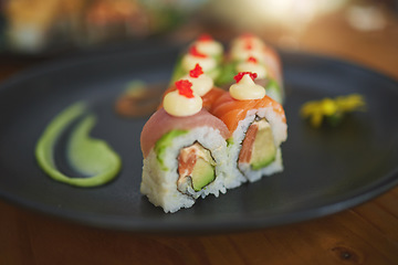 Image showing Sushi restaurant, catering and plate in closeup for service, lunch and dinner for Philadelphia roll, chopsticks and fish. Japanese cuisine, platter and food in cafe, luxury and eating for nutrition