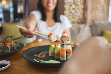 Image showing Hands, chopsticks and sushi restaurant with friends, smile and excited for fine dining, party and share. Happy women, fish and healthy with culture, traditional or fast food in diner, bar or shop