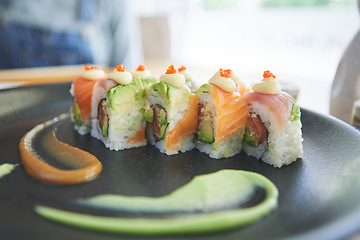 Image showing Asian, sushi and plate of food at a restaurant for dinner or lunch meal at healthy Japanese cafe on table. Plate, cuisine and fine dining takeaway or seafood from a Salmon menu for diet or nutrition