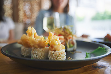 Image showing Asian, sushi and food at a restaurant for dinner or lunch meal at a healthy Japanese cafe on table. Plate, cuisine and luxury fine dining takeaway or seafood from a Salmon menu for diet or nutrition