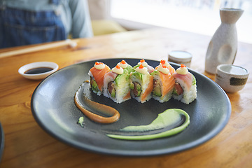 Image showing Asian, sushi and luxury food at a cafe for dinner or lunch meal at a healthy Japanese restaurant on table. Plate, cuisine and fine dining takeaway or seafood from a Salmon menu for diet or nutrition