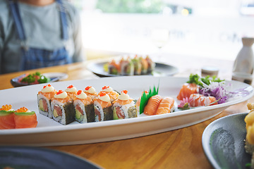 Image showing Asian, sushi and luxury food at a restaurant for dinner or lunch meal at a healthy Japanese cafe on table. Plate, cuisine and fine dining takeaway or seafood from a Salmon menu for diet or nutrition