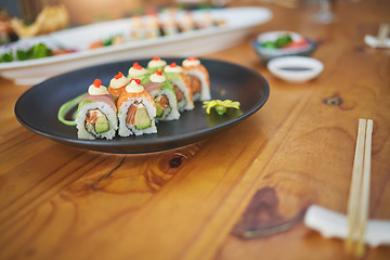 Image showing Restaurant, meal and closeup of sushi on a plate for luxury, healthy and authentic Asian cuisine. Platter, fine dining and zoom of a Japanese food for lunch, dinner or supper at a traditional cafe.