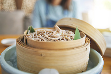 Image showing Restaurant, steamer and closeup of a bowl of noodles for healthy Asian cuisine for diet. Food, bamboo pot and zoom of Japanese ramen for a nutrition meal for dinner, lunch or supper at a diner.