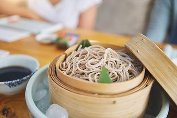 Image showing Restaurant, bamboo and closeup of a bowl of noodles for authentic Asian cuisine for diet. Food, steamer pot and zoom of Japanese ramen for a nutrition meal for dinner, lunch or supper at a diner.