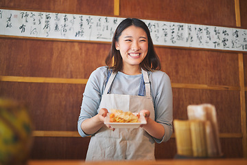 Image showing Chinese food, waitress and an asian woman in a sushi kitchen to serve a traditional meal for nutrition. Restaurant, smile and cooking with a happy young employee in an eatery for fine dining cuisine