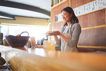 Image showing Chinese food, waitress and an asian woman in a sushi restaurant to serve a traditional meal for nutrition. Kitchen, smile and cooking with a happy young employee in an eatery for fine dining cuisine