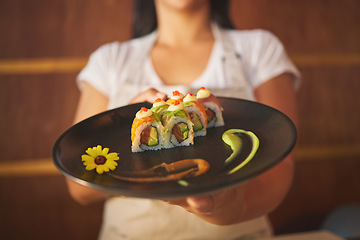 Image showing Sushi plate, waiter hands and restaurant with service, helping and catering job in closeup. Small business, fast food server and cooking in cafe, startup diner and working with fish, rice or seaweed