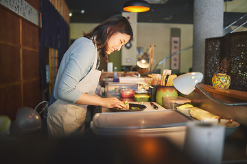 Image showing Sushi chef, restaurant and prepare in kitchen with start, service or plate on table, job or catering. Small business, fast food and cooking in cafe, startup diner and smile with fish, rice or seaweed