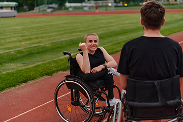 Image showing A woman with disability in a wheelchair talking with friend after training on the marathon course